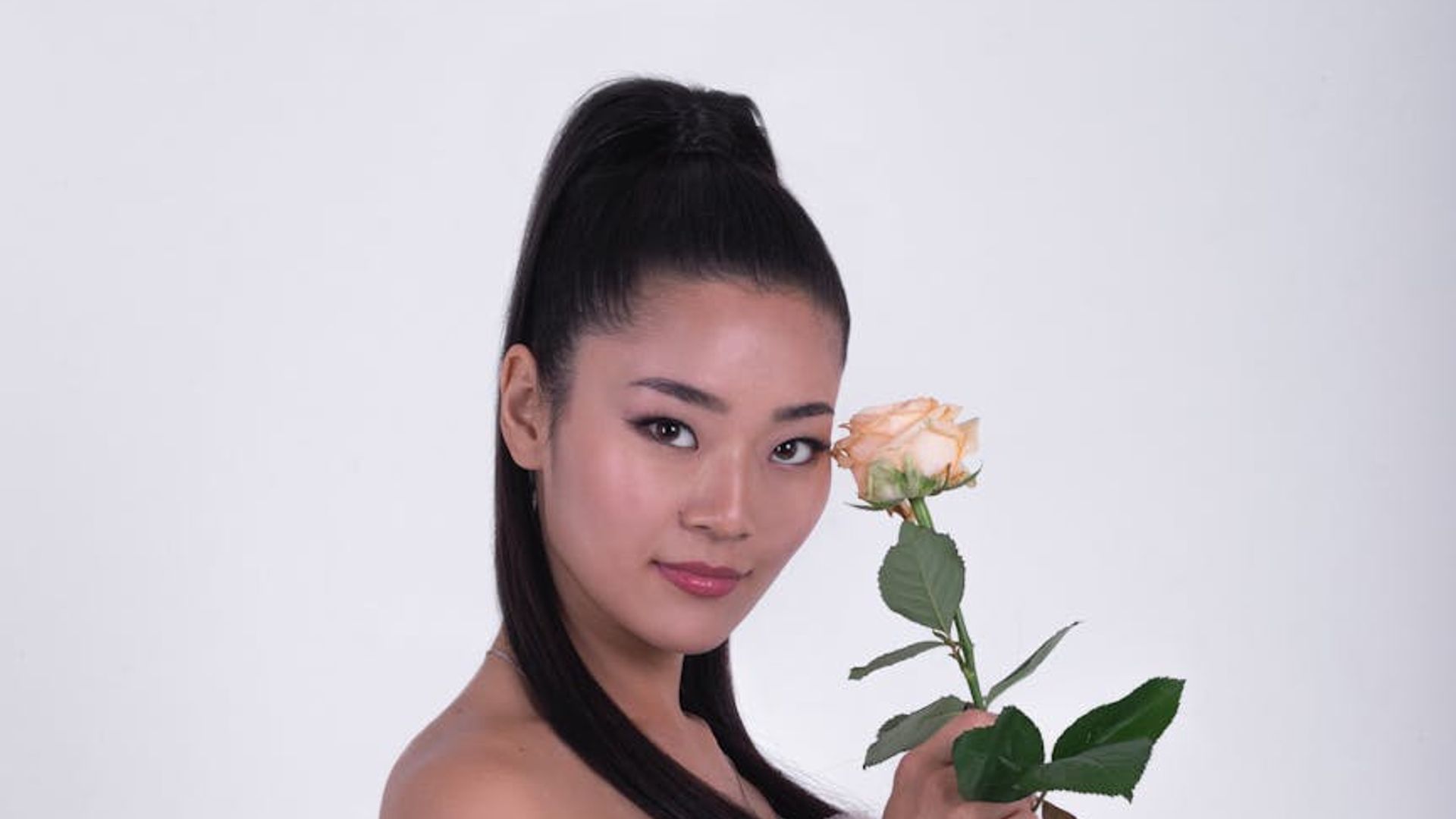 Silhouette of a person in a dynamic pose against a dark, minimalist background with an amber glow.